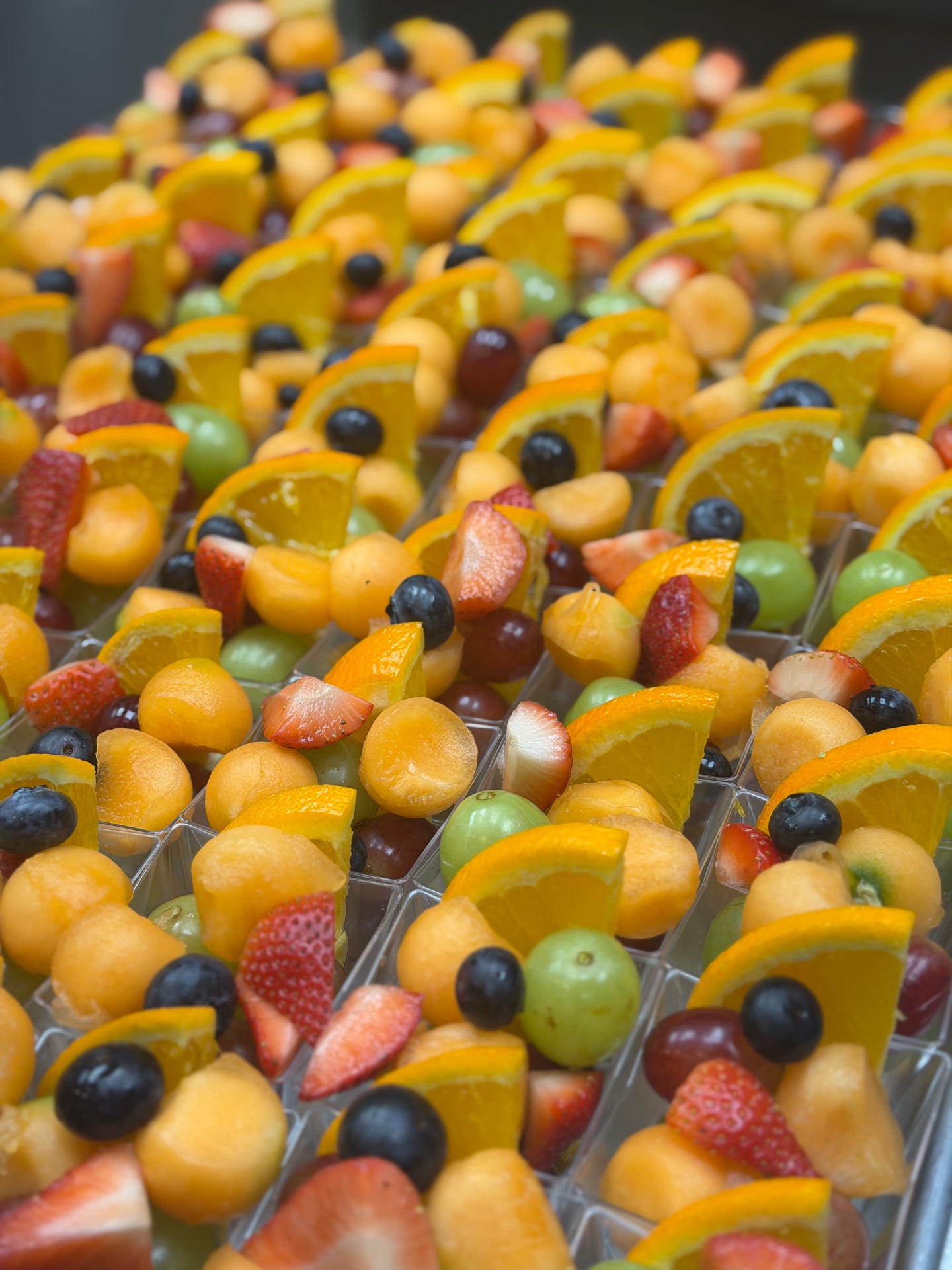 Fresh fruit cups with melon, berries and citrus