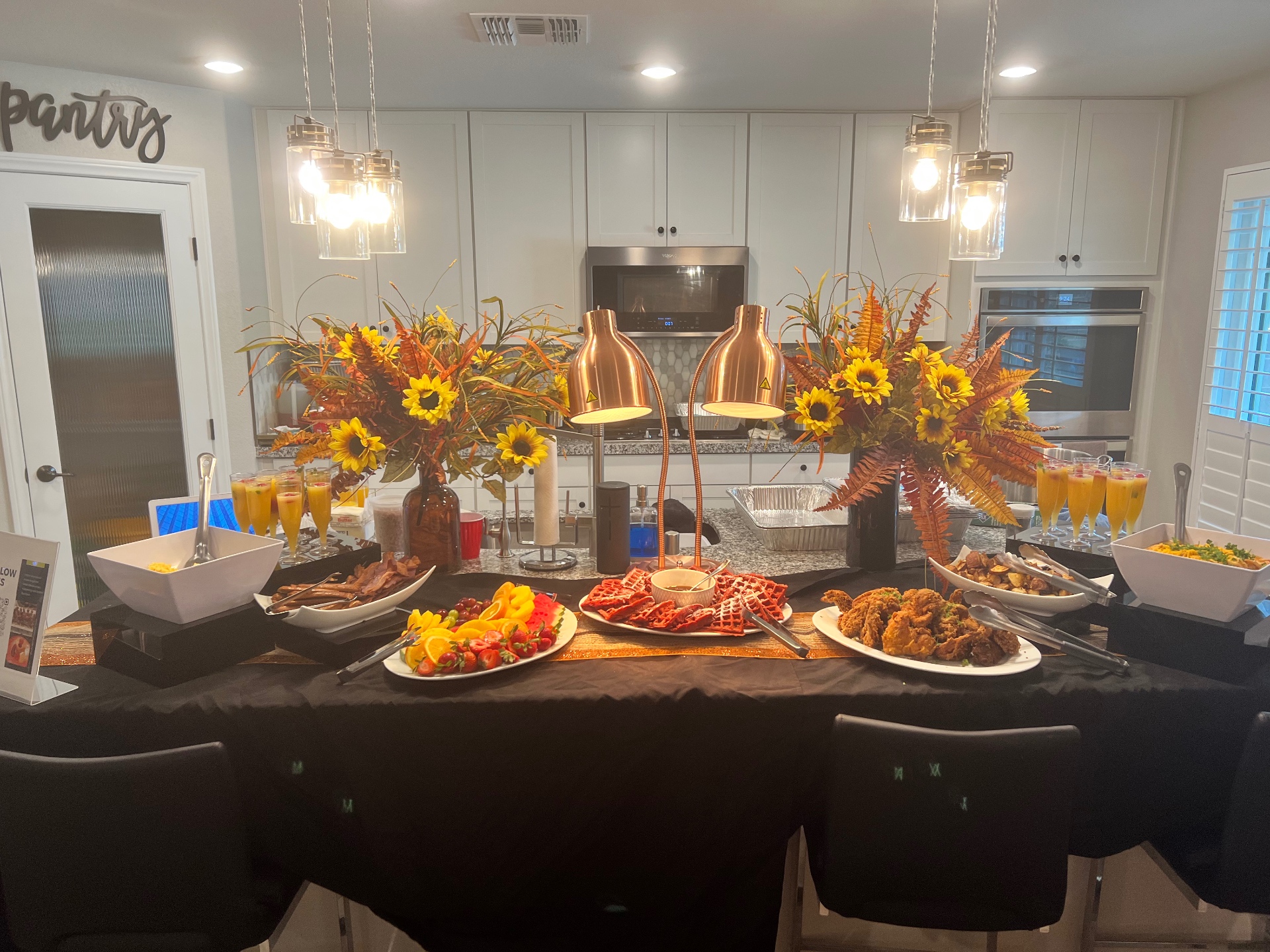Breakfast buffet with waffles, fruit and chicken